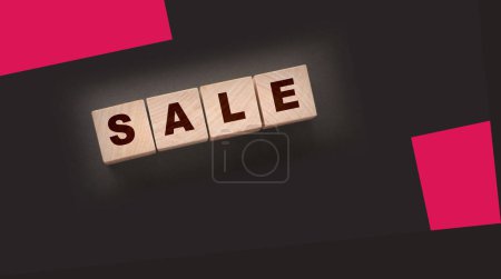 Photo for The word sale on wooden cubes on a black background. Business concept - Royalty Free Image