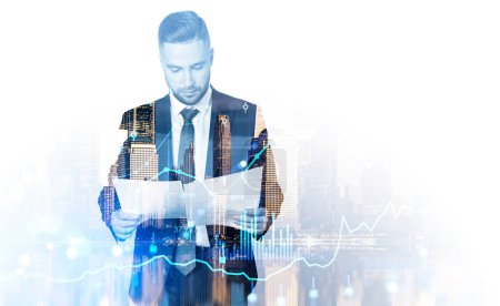 Photo for Attentive handsome businessman wearing formal suit standing reading notes. Forex candlesticks and bar diagrams. City skyscrapers. Concept of busy successful trader, trading on stock market, income - Royalty Free Image