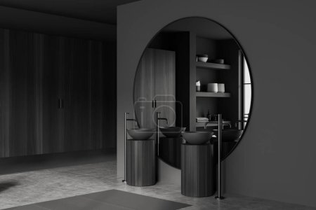 Téléchargez les photos : Intérieur de salle de bain sombre avec double lavabo et grand miroir rond, tapis de vue latérale sur sol en béton gris. Étagère avec décoration minimaliste et fenêtre. rendu 3D - en image libre de droit