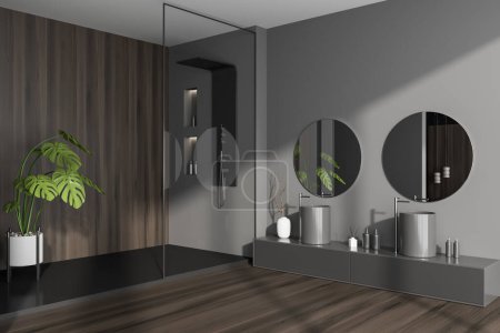 Photo for Dark bathroom interior with shower and glass partition, side view. Double sink with dresser and accessories on hardwood floor. 3D rendering - Royalty Free Image