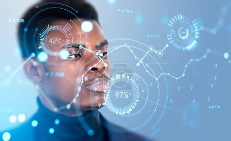 Foto de Serious African American businessman in formal wear watching at digital interface with forex chart, graph and diagrams. Concept of trading on stock market, share exchange, profitable commercial deals - Imagen libre de derechos