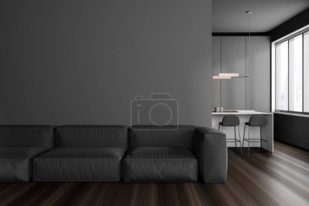 Photo for Dark studio interior with sofa and bar island with chairs, hidden kitchen shelves and panoramic window on Singapore skyscrapers. Mockup copy space wall. 3D rendering - Royalty Free Image