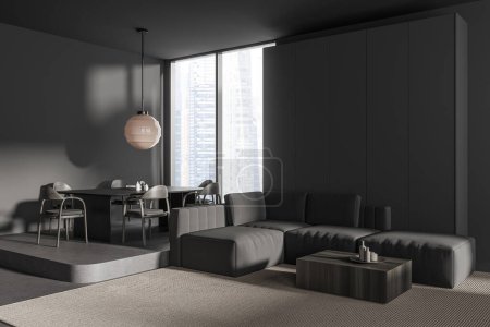 Photo for Corner view on dark studio room interior with sofa, armchairs, dining table, grey wall, coffee table, carpet, panoramic window with city view, concrete floor. Minimalist design. 3d rendering - Royalty Free Image