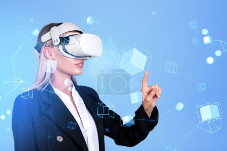Photo for Businesswoman wearing vr headset is watching at metaverse reality with blockchain system. Blue background. Concept of modern technology and progressive currency in business, ambitious business person - Royalty Free Image
