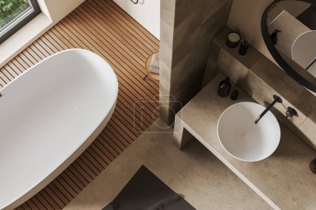 Photo for Top view of beige bathroom interior with sink and tub near window. Bathing corner with bathtub and washbasin with hotel accessories. 3D rendering - Royalty Free Image