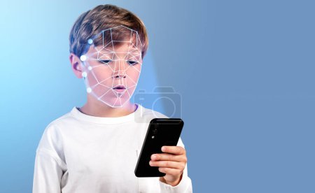 Photo for Concentrated boy with smartphone in hand, digital biometric scanning hologram. Face detection and recognition. Concept of face id and education - Royalty Free Image