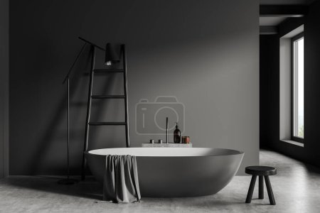 Photo for Front view on dark bathroom interior with large bathtub, window, grey walls, stool, shelf with shampoo, towel, concrete floor. Concept of water treatment. 3d rendering - Royalty Free Image