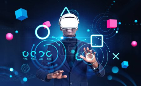 Téléchargez les photos : African American businessman wearing formal suit and vr headset touching metaverse reality with blockchain system. Dark background, pie diagram, spheres. Concept of modern technology and playing game - en image libre de droit
