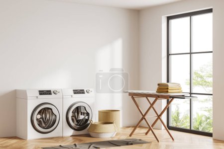 Téléchargez les photos : White laundry interior with two washing machines and ironing board, side view. Panoramic window on tropics, carpet on hardwood floor. Mockup copy space. 3D rendering - en image libre de droit