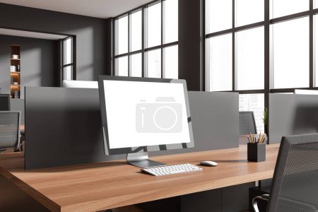 Foto de Dark workplace interior with pc computer, side view wooden desk with tools. Panoramic window on skyscrapers. Mockup blank screen. 3D rendering - Imagen libre de derechos