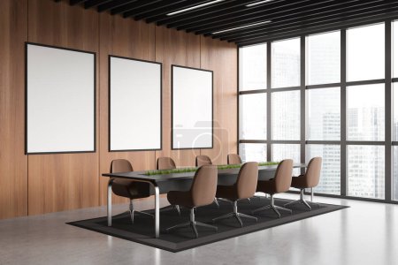 Téléchargez les photos : Modern conference room interior with armchairs and board, side view. Meeting corner with panoramic window on skyscrapers. Three mockup posters. 3D rendering - en image libre de droit