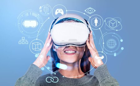 Foto de Happy businesswoman in vr glasses, metaverse hologram hud with accessories and connection icons. Concept of virtual reality and futuristic technology - Imagen libre de derechos