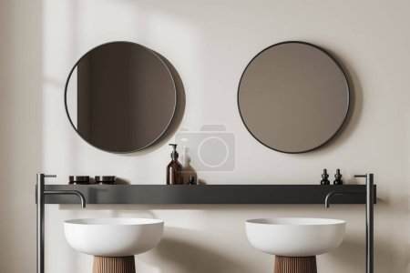 Téléchargez les photos : Beige bathroom interior with double sink and shelf with accessories. Two round mirrors and long faucets. 3D rendering - en image libre de droit
