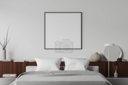 Foto de Front view on bright bedroom interior with empty white poster, bed, bedsides, shelf with books, round mirror, white wall. Concept of minimalist design, chill and relaxation. Mock up. 3d rendering - Imagen libre de derechos