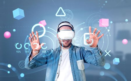 Photo for Businessman wearing casual wear and vr headset touching metaverse reality with blockchain system. Office in background, pie diagram. Concept of modern technology and progressive currency in business - Royalty Free Image