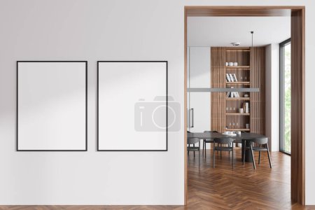 Téléchargez les photos : White living room interior with dining table on hardwood floor. Shelf with decoration and panoramic window on tropics. Two mock up posters on partition. 3D rendering - en image libre de droit
