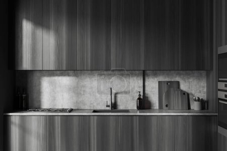 Téléchargez les photos : Dark kitchen interior with sink and stove, minimalist kitchenware with dishes and black wooden shelves. Dark cooking area with hidden design. 3D rendering - en image libre de droit