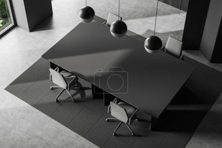 Foto de Top view of dark conference room interior with armchairs, carpet on grey concrete floor. Office meeting corner with window. 3D rendering - Imagen libre de derechos