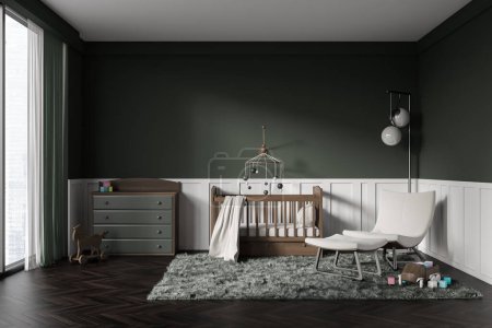 Téléchargez les photos : Front view on dark baby room with child bed, armchair, green and white wall, oak wooden hardwood floor, panoramic window. Concept of nursery in soft design, cozy space for newborn kid. - en image libre de droit