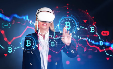 Photo for Businesswoman in vr glasses, fingers touching virtual screen with falling bitcoin, red candlesticks and lines. Concept of crisis and cryptocurrency. - Royalty Free Image