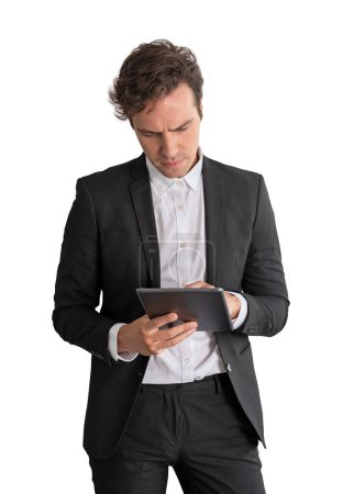 Foto de Serious businessman working in tablet, concentrated portrait with device in hand. Online network and social media, isolated over white background. Concept of management - Imagen libre de derechos