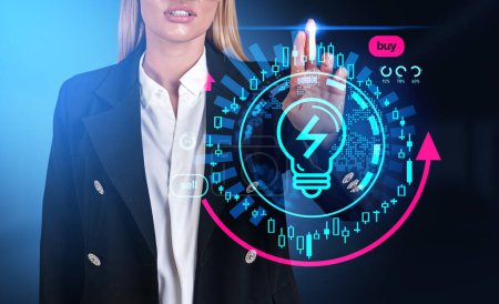 Foto de Businesswoman in formal wear touching digital interface with light bulb, pie and bar diagram. Concept of troubleshooting of worldwide electricity energy crisis, power resources deficit, trading - Imagen libre de derechos