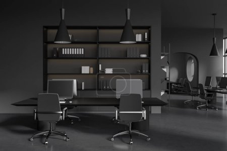 Photo for Dark coworking interior with pc desktop on table and armchairs on grey concrete floor. Office open space loft with shelf and decoration. 3D rendering - Royalty Free Image