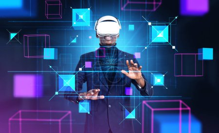 Photo for African American businessman wearing vr headset is watching at metaverse reality with blockchain system. Dark background. Concept of modern technology, progressive currency in business - Royalty Free Image