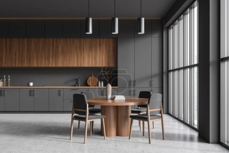 Téléchargez les photos : Front view on dark kitchen room interior with dining table with armchairs, panoramic window, grey wall, concrete floor, cupboard. Concept of minimalist design. 3d rendering - en image libre de droit