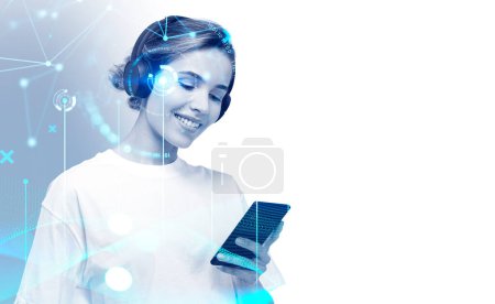 Téléchargez les photos : Smiling attractive businesswoman wearing formal wear standing listening podcast on smartphone via headphones with digital interface in background. Concept of ambitious business person, inspired woman - en image libre de droit