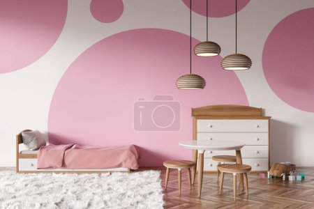 Foto de Pink and white baby room interior with bed and carpet on hardwood floor. Sideboard and toys, dining table with stool. 3D rendering - Imagen libre de derechos
