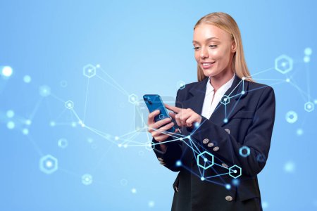 Téléchargez les photos : Attractive businesswoman in formal wear standing holding smartphone with digital interface with network in background. Concept of dreaming business person, social media, internet communication - en image libre de droit