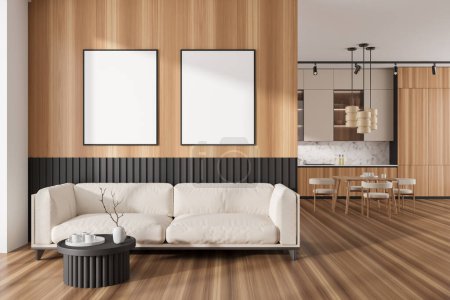 Foto de Wooden kitchen interior with lounge zone, sofa and dining table with chairs on hardwood floor. Chill and eating area in modern apartment. Two mockup posters in row. 3D rendering - Imagen libre de derechos