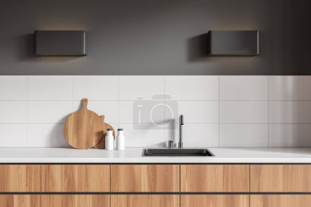 Téléchargez les photos : Modern kitchen interior with sink and deck with minimalist kitchenware. Cooking corner with wooden shelves, lamp on grey wall. 3D rendering - en image libre de droit