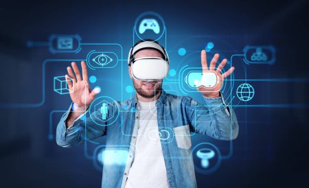 Téléchargez les photos : Young man in vr headset hands touching cyberspace hologram with glowing icons circuit. Concept of virtual world and immersive technology - en image libre de droit