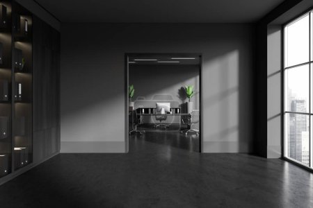 Téléchargez les photos : Dark consulting interior with pc computer and work desk, grey concrete floor. Minimalist stylish shelf in hall with panoramic window on skyscrapers. 3D rendering - en image libre de droit