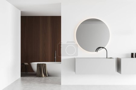 Téléchargez les photos : White bathroom interior with sink and round mirror, bathtub with towel in the corner on light concrete floor. Modern hotel washing room. 3D rendering - en image libre de droit