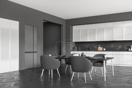Téléchargez les photos : Grey kitchen interior with armchairs and eating table on black hardwood floor, side view. Kitchenware, sink and fridge. Open space cooking area. 3D rendering - en image libre de droit