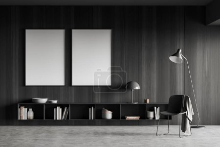 Photo for Dark lounge zone interior with chair and lamp, dresser with art decoration, grey concrete floor. Two mock up blank poster on black wooden wall. 3D rendering - Royalty Free Image