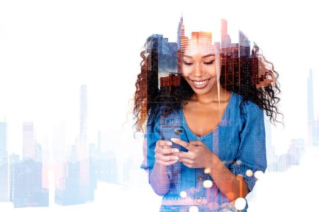 Photo for Happy african woman portrait working with phone, double exposure with skyscrapers silhouette. Concept of business network and mobile app - Royalty Free Image