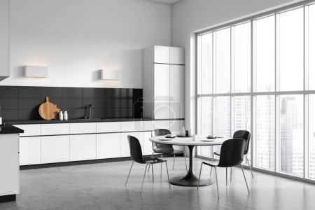 Foto de White and black kitchen interior with dining table and chairs, side view shelves with kitchenware on grey concrete floor. Panoramic window on city view. 3D rendering - Imagen libre de derechos