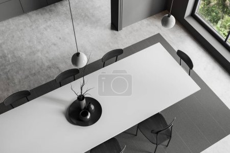 Foto de Top view of dark kitchen interior with dining table and chairs, carpet on grey concrete floor. Panoramic window on tropics. 3D rendering - Imagen libre de derechos