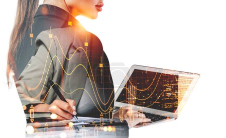 Photo for Two businesswomen wearing formal wear are working together using laptop and taking notes. City skyscraper downtown. Forex financial chart and graph. Concept of teamwork and trading on stock market - Royalty Free Image