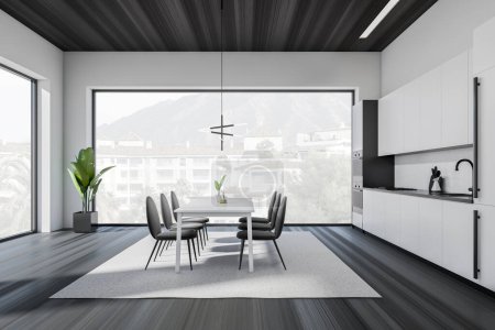 Foto de Side view on dark kitchen room interior with dining table with chairs, panoramic window, cupboard, white wall, sink, plates, lamps, oil, wooden floor. Concept of minimalist design. 3d rendering - Imagen libre de derechos