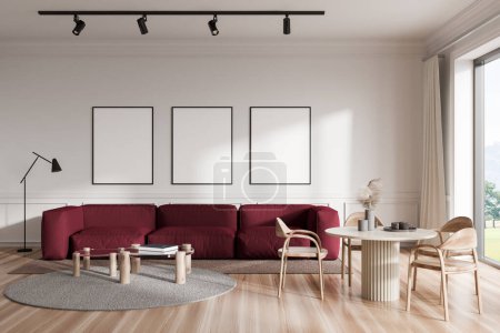 Photo for Stylish living room interior with sofa and dining table, chairs on hardwood floor. Panoramic window on countryside. Chill area and three mockup posters on white wall. 3D rendering - Royalty Free Image