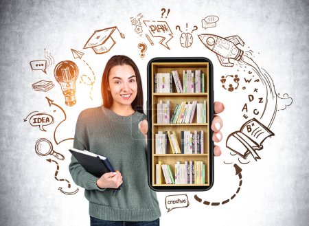 Photo for Young woman smiling with smartphone in hands, doodle sketch with lightbulb, plan, idea on grey concrete background. Concept of education and creativity. Concept of digital library - Royalty Free Image