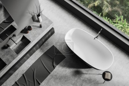 Foto de Top view of dark bathroom interior with sink and bathtub near panoramic window. Hotel bathing corner with dresser on grey concrete floor. 3D rendering - Imagen libre de derechos