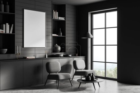 Foto de Dark living room interior with two armchairs and drawer with decor, side view on grey concrete floor. Panoramic window on countryside. Mock up canvas poster. 3D rendering - Imagen libre de derechos