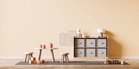 Foto de Front view on bright baby room with empty peach wall, child toy, wooden hardwood floor, sideboard, table with stools, lamp. Concept of nursery in soft design, cozy space for newborn kid - Imagen libre de derechos