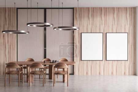 Photo for Wooden dining room interior with chairs and dishes on dining table, light concrete floor. Two mock up canvas posters on wooden wall, 3D rendering - Royalty Free Image